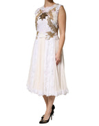 Elfenbeinfarbenes, ärmelloses Seidenkleid mit Spitze und Verzierungen