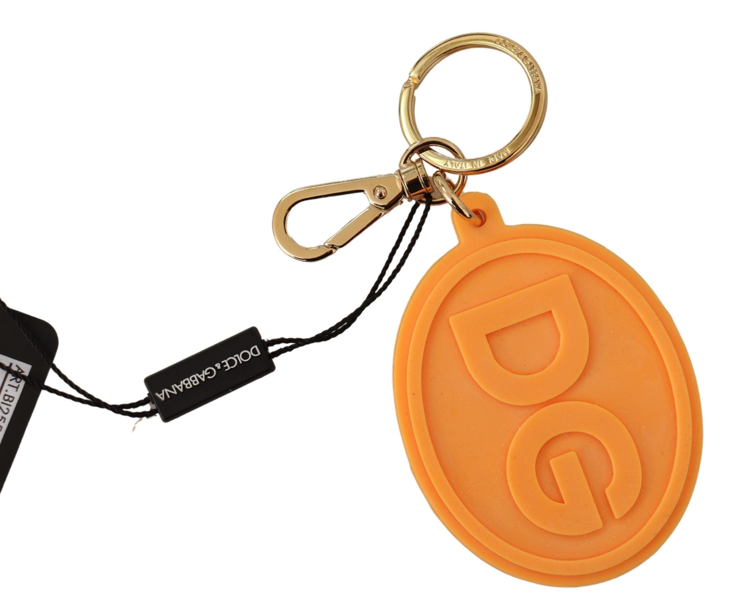 Orangefarbener Gummi-Schlüsselanhänger mit DG-Logo aus goldfarbenem Messing