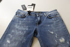 Jeans in denim di cotone délavé blu a vita bassa e gamba aderente