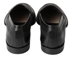 Schwarze Slipper aus Leder mit Ziernähten